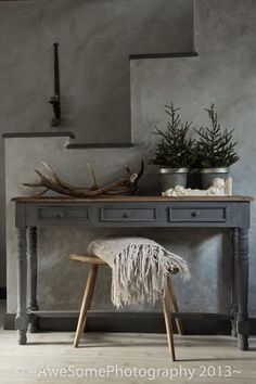 a table with a chair and some plants on it