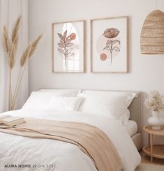 a bedroom with two framed pictures above the bed