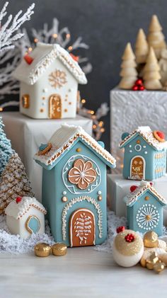 small blue and white gingerbread houses next to christmas trees