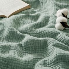 a book and some cotton on a bed