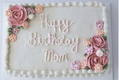 a birthday cake decorated with pink flowers and the words happy birthday mom written on it