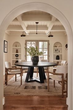 an archway leads to the dining room and living room, which also has built in shelving