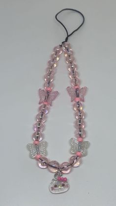 a necklace with pink beads and butterfly charms