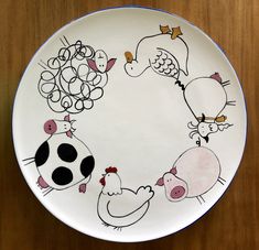 a plate with farm animals painted on it