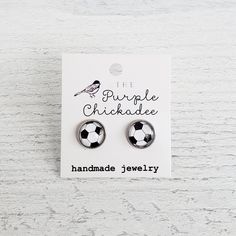 the purple chickade soccer ball stud earrings are shown in front of a white background