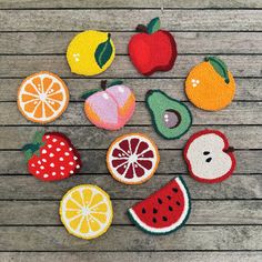 fruit appliques are laid out on a wooden surface