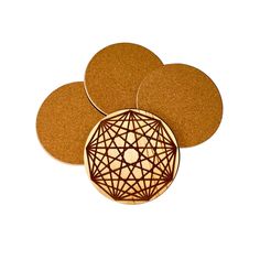 three cork coasters sitting on top of each other with an intricate design in the middle