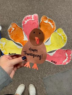 someone holding up a turkey shaped card with the words happy thanksgiving