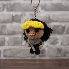 a crocheted doll hanging from a keychain