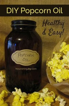 popcorn oil in a glass jar next to some paper bags with popcorn on it and the text, diy popcorn oil healthy & easy