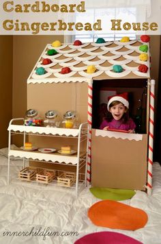 a cardboard gingerbread house made to look like a child's play house