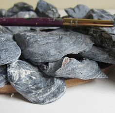 a pile of rocks with a pencil on top of it next to some other rocks