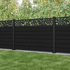 a black fence in the middle of some grass