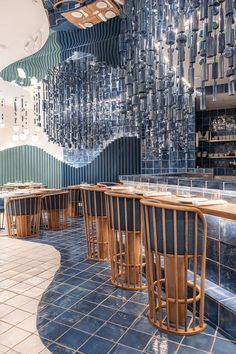 the interior of a restaurant with blue tiled walls