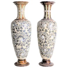 two large vases sitting next to each other