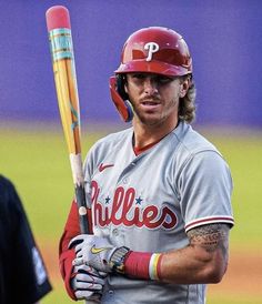 a baseball player holding a bat on top of a field