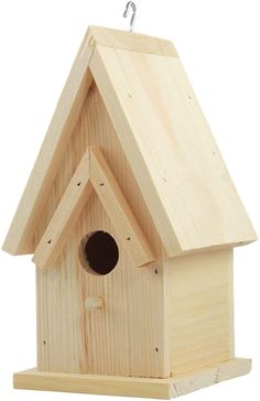 a wooden birdhouse with a black hole in the roof