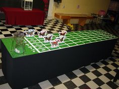 a table with paper cut out of horses on it in the middle of a room