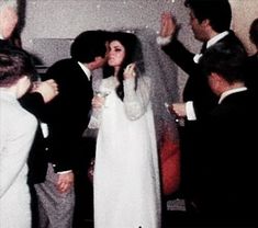 a bride and groom kissing in front of their guests