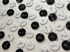 many black and white tags with names on them