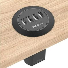 an electrical outlet on a wooden surface with the word simpak written below it