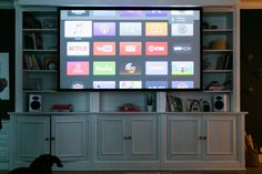 a flat screen tv sitting on top of a white entertainment center