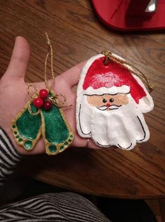 two handmade christmas ornaments in the shape of santa claus