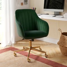 a green office chair sitting in front of a computer monitor on top of a desk