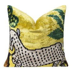 a yellow and green pillow with a horse on it's front end, sitting on a white surface