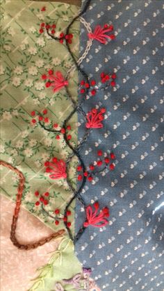 two pieces of fabric with red flowers on them, one is blue and the other has white dots