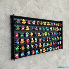 a wall mounted shelf filled with lots of cartoon figurines