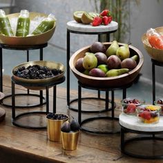 there are many different types of fruit in bowls on the table and one is empty