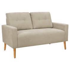 a beige couch sitting on top of a white floor next to a wooden leg chair