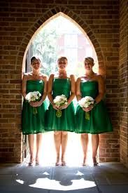 a group of women in green dresses standing next to each other