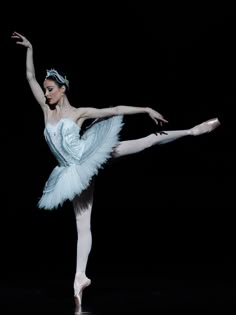 the ballerina is dressed in white and blue