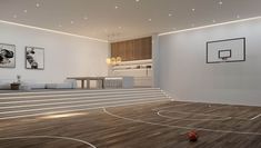 an indoor basketball court with stairs leading up to it