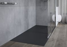 a bathroom with a glass shower door and wood flooring on the walls, along with a toilet and urinal