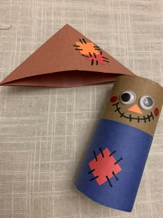 a toilet paper roll decorated like a scarecrow