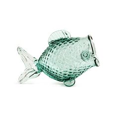 a glass fish figurine on a white background