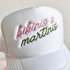 Bikinis & Martinis Embroidered Trucker Hat 100% polyester Foam trucker hat with mesh back, adjustable snap closure and embroidered design. Adjustable Flat Brim Trucker Hat For Summer, White Trucker Hat For Beach Season, Adjustable Trucker Hat With Embroidered Logo And Flat Brim, Adjustable Trucker Snapback Hat For Summer, Adjustable Trucker Hat With Embroidered Logo And Visor, Beach Mesh Snapback Hat, Mesh Snapback Baseball Cap For Beach, Summer White Trucker Hat With Embroidered Logo, White Embroidered Logo Trucker Hat For Summer