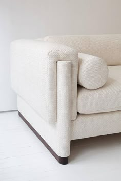 a white couch sitting on top of a hard wood floor