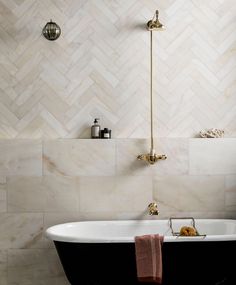 a bath tub sitting next to a shower head and faucet in a bathroom