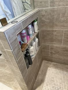 a bathroom with gray tile and white tiling