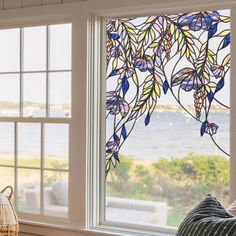 a living room with two windows that have stained glass designs on the window sill