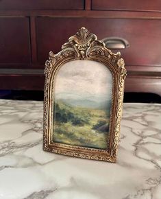 an ornate frame sitting on top of a marble counter