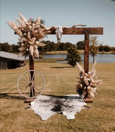 an old wagon is decorated with pamodia and feathers for a rustic wedding ceremony