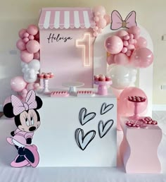 a minnie mouse birthday party with balloons and decorations