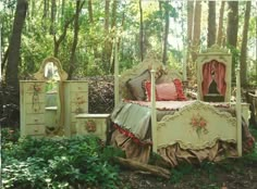 an old fashioned bed in the woods surrounded by greenery