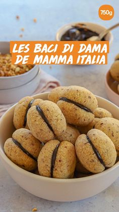 a bowl full of cookies with chocolate drizzled on them and some cereal in the background