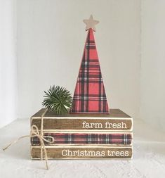 a stack of books with a christmas tree on top and the words farm fresh, christmas trees